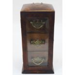 A Victorian walnut table top cabinet, late 19th century, the door with beveled glass enclosing three