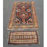 A West Persian rug with two medallions, together with a small Caucasian rug (2) Provenance: the