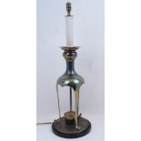 A brass table lamp, 20th century, the faux candlestick electrical fittings with large sconce atop