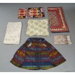 A collection of mixed textiles, 20th century, of Indian and Nepalese origin, to include: Ikat panels