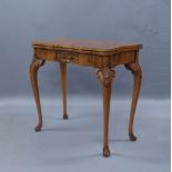 A Queen Anne style walnut fold over card table, late 20th century, with single drawer raised on