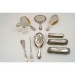 A group of silver mounted vanity items, comprising: a mirror and three matching brushes, with