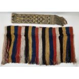 Two bed ornaments, 20th century, one of multi-coloured striped pattern with hanging tassels,