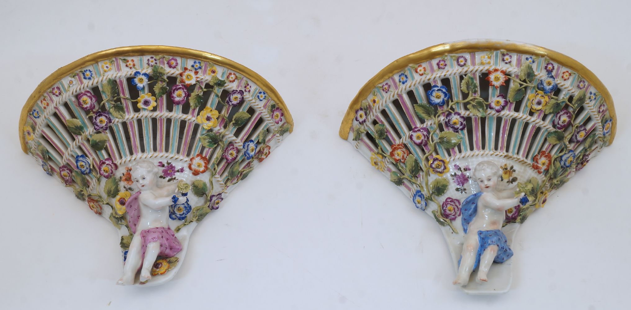 A pair of Dresden wall brackets, early 20th century, of pierced trellis design with encrusted