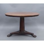 A William IV mahogany tilt top table, raised on tri-form base, paw feet and castors, 71cm high,