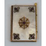 A French gilt-brass and mother-of-pearl aide memoire, early 20th century, in the form of a book, the