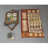 A mixed collection of tribal textiles and ornaments, 20th century, to include a leather and beadwork