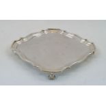 A silver salver, London, 1912, Horace Woodward & Co Ltd, of shaped square form on four scroll