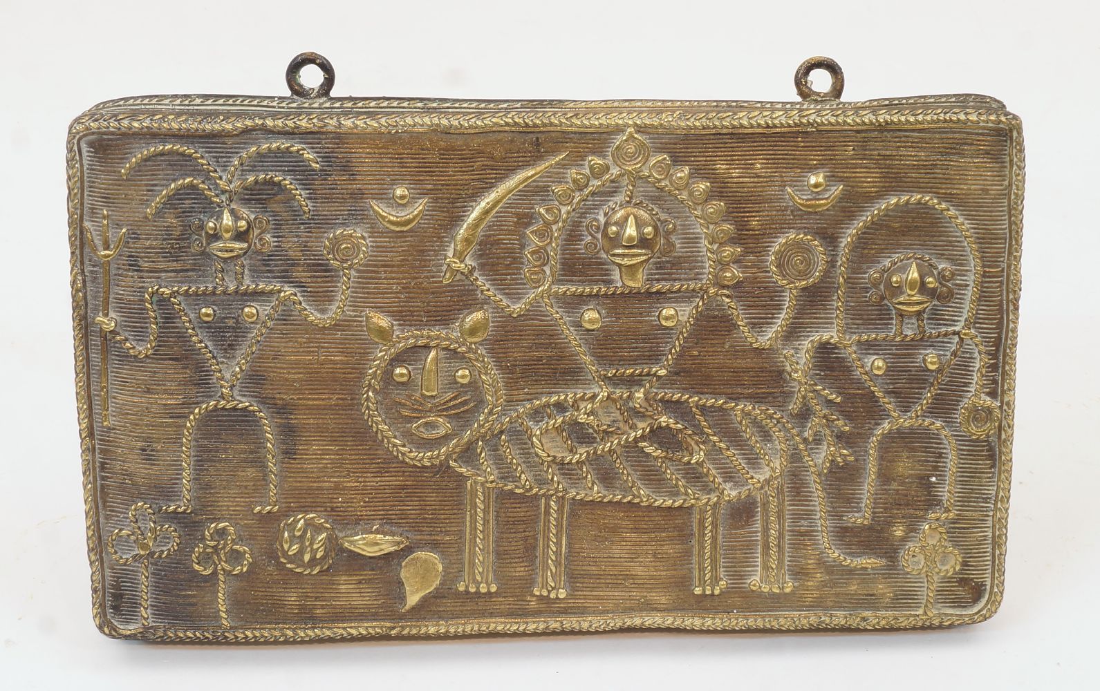 An Indian gilt-brass plaque, late 19th / early century, depicting the Goddess Durga riding a tiger