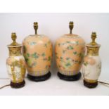 A pair of Japanese vase lamps, 20th century, with floral decoration, on pierced wood bases, 35cm