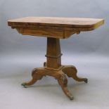 A Regency mahogany fold over tea table, the rectangular top with rounded edges, above trapezium