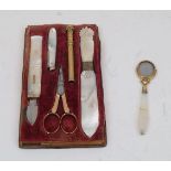 A set of Victorian mother-of-pearl stationary implements, in a velvet lined fitted tray (