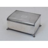 An engine-turned silver cigarette box, Birmingham, 1936, Bravingtons Ltd, the hinged lid with engine