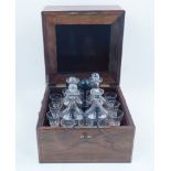 An Edwardian mahogany satinwood inlaid decanter set, the hinged top with line inlay and floral