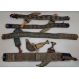 A group of five jambiya daggers with attached embroidered belts, South Arabia, 20th century, of