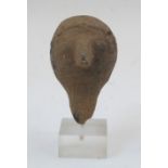 A small antique style carved stone head of a bearded man, 20th century, mounted on a perspex base,
