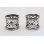 A pair of Victorian pierced napkin rings, with pierced quatrefoil decoration and gadrooned rims,