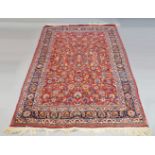 A West Persian carpet with all over floral and foliate design in deep red field, mid 20th century,