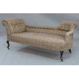 A Victorian chaise lounge, upholstered in a William Morris style fabric, raised on ebonised supports