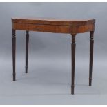 A George III mahogany card table, boxwood inlaid, raised on reeded tapered legs, 73cm high, 92cm