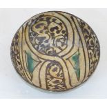 An Islamic underglazed Buffware style pottery bowl, 20th century, of deep form, decorated with