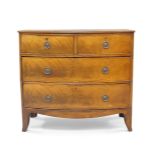 A Regency mahogany bow front chest of drawers, two short over two long, raised on out swept feet,