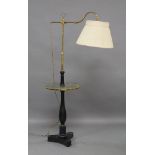 A floor standing brass and wood reading lamp, 20th century, with adjustable stem and arm and