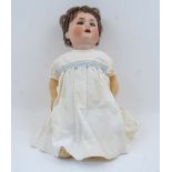 A Schutzmeister & Quendt 201 bisque headed doll, on bent limbed composition body, 54cm longPlease