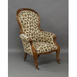 A Victorian mahogany spoon back armchair, scrolling frame with serpentine front, recent leopard