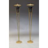 A pair of Mid Century style uplighter floor lamps, on four cylindrical supports to circular base,