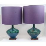 A pair of Italian ceramic table lamps, 20th century, of bottle shape with mottled green and