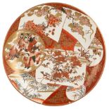 A Japanese Kutani charger, Meiji period, painted with seven panels enclosing scenes of immortals,