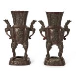 A pair of Japanese bronze vases, Meiji period, cast with alternating panels of birds and foliage,
