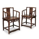 A pair of Chinese walnut armchairs, early 19th century, the central splat carved with a ruyi above a