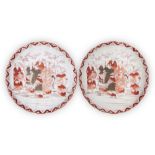 A pair of Japanese Kutani plates, late Meiji period, decorated with immortals in a bamboo grove,