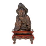 A Japanese carved wood 'Fukurokuju' figure, 19th / 20th century, the old man wearing a hat and