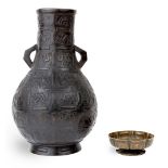 A Japanese twin handled bronze baluster vase, 19th century, standing on a splayed foot rising to a