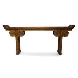 A Chinese elm wood altar table, early 20th century, the flat top carved from one piece of wood