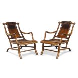 A pair of Chinese hongmu reclining 'moongazing' chairs, late Qing dynasty, the shaped scroll-cared