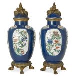A pair of Chinese powder-blue ground famille verte jars and covers, 18th century, each painted to