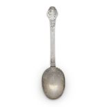 A lace-back silver trefid spoon, unmarked, the reverse of bowl and front of terminal with foliate