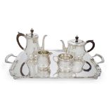 An Elizabeth II silver four-piece tea set with earlier tray, the tea set London, 1979, Wakely &