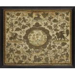 A Charles II silk embroidered panel, c.1660-70, with central oval cartouche of a pastoral scene with