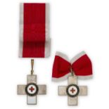 Two German Red Cross (DRK) II Class Medals, each consisting of a Geneva cross with white enamelled
