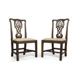 A pair of George III mahogany side chairs, in the manner of Chippendale, with pierced central