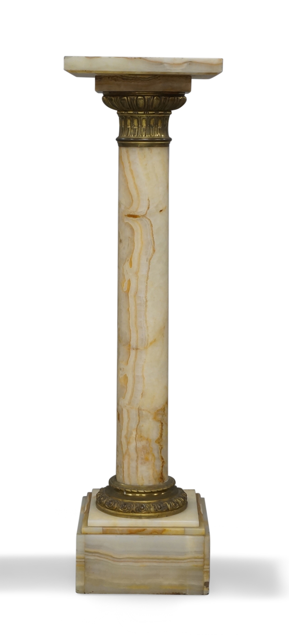 A gilt-bronze mounted onyx column, early 20th century, with stop-fluted capital, 107cm high, the