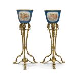 A pair of French gilt-bronze mounted Sevres jardinieres-on-stands, first half 20th century, the