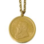 A 9ct gold pendant mounted South African Krugerrand coin, 1974, to a 9ct gold cable link neck chain,