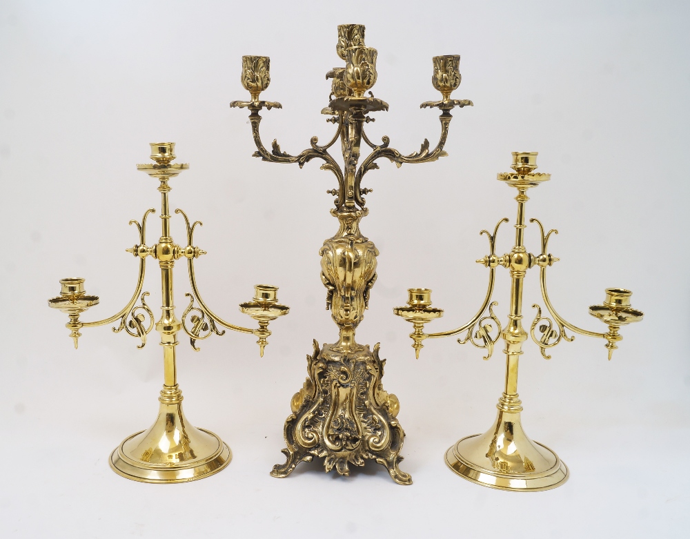 A pair of Victorian brass three light candelabra, the central knopped stem and two protruding