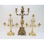 A pair of Victorian brass three light candelabra, the central knopped stem and two protruding